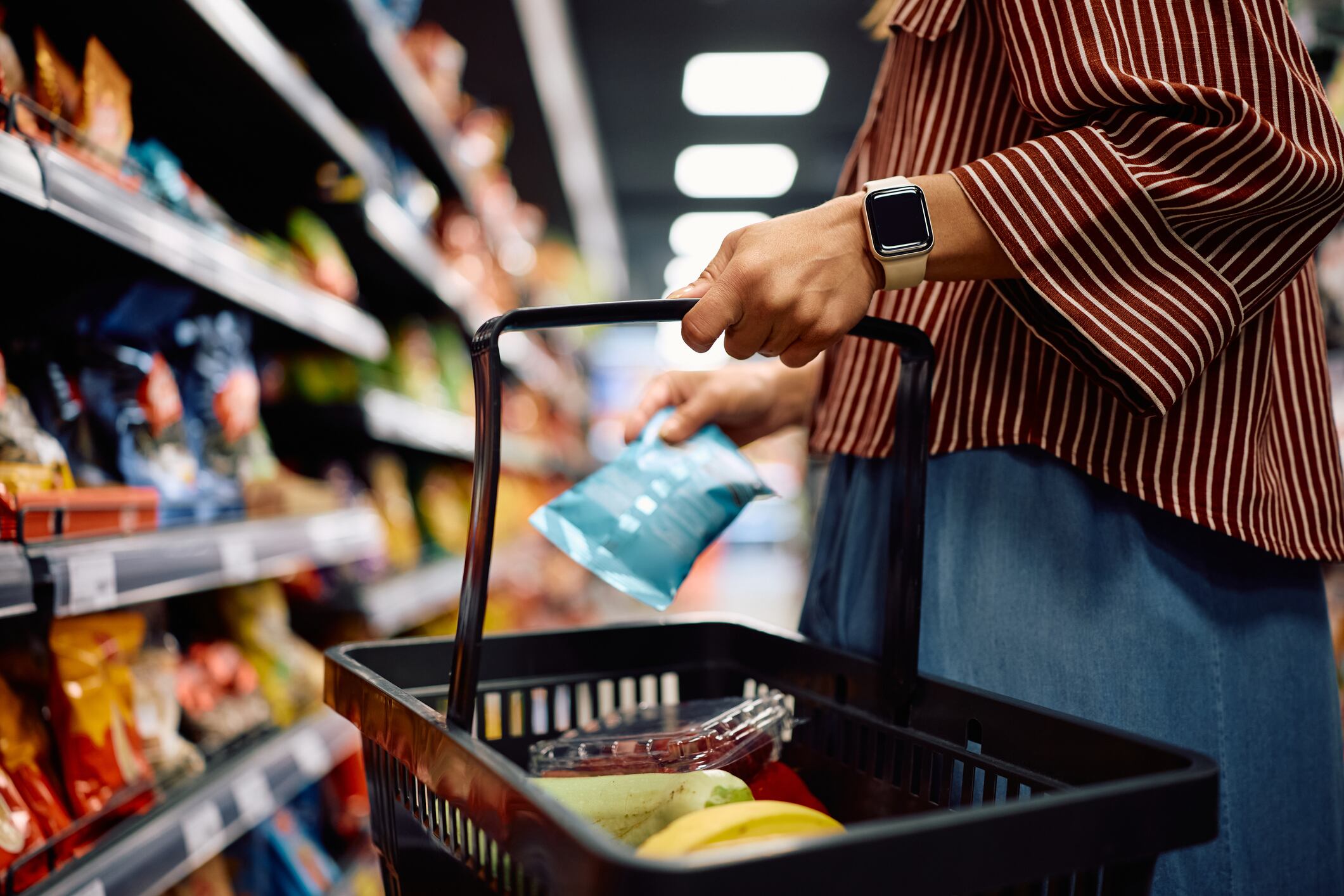 Close up of woman shopping groceries in supermarket.