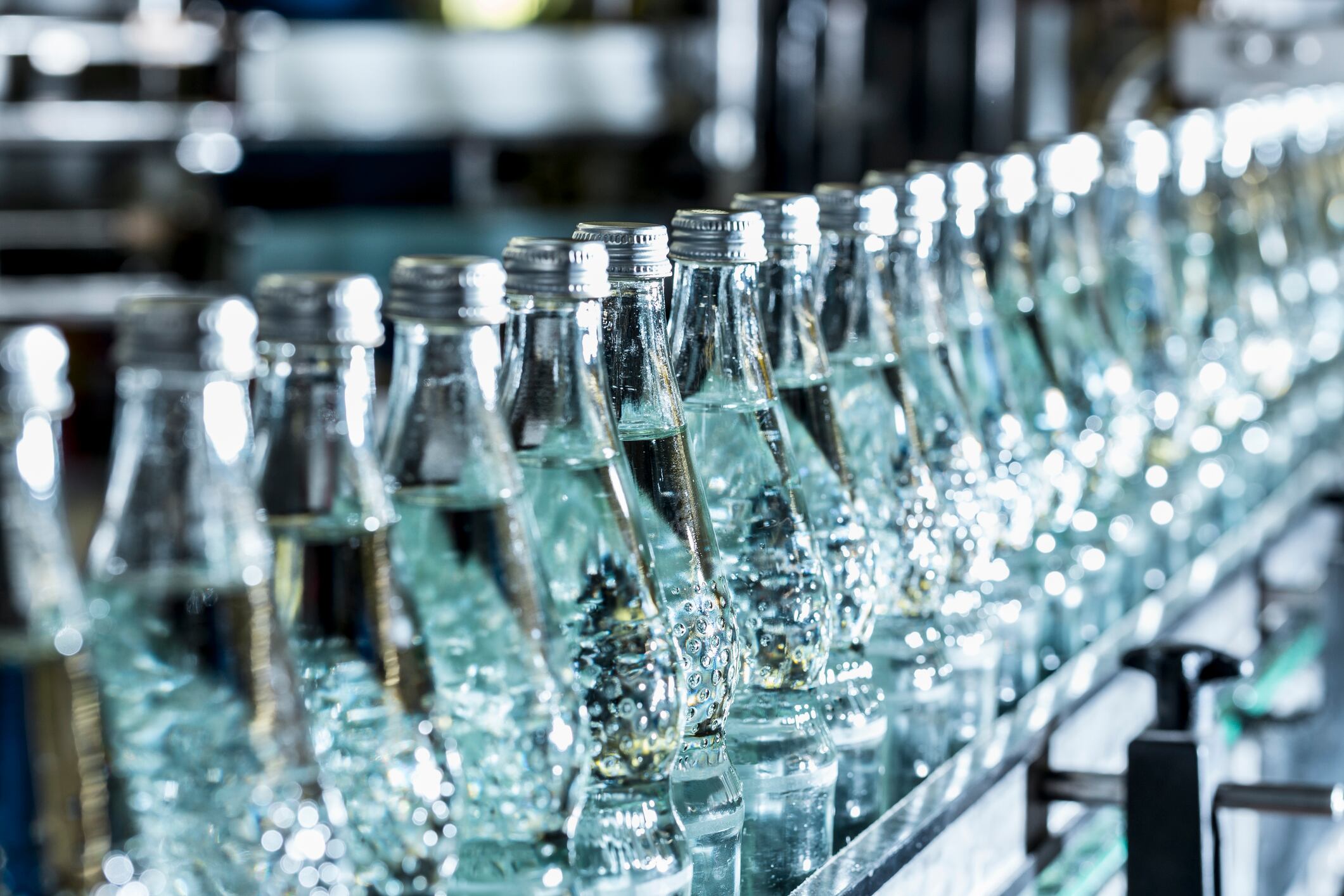 Row of mineral water bottles on conveyor belt
