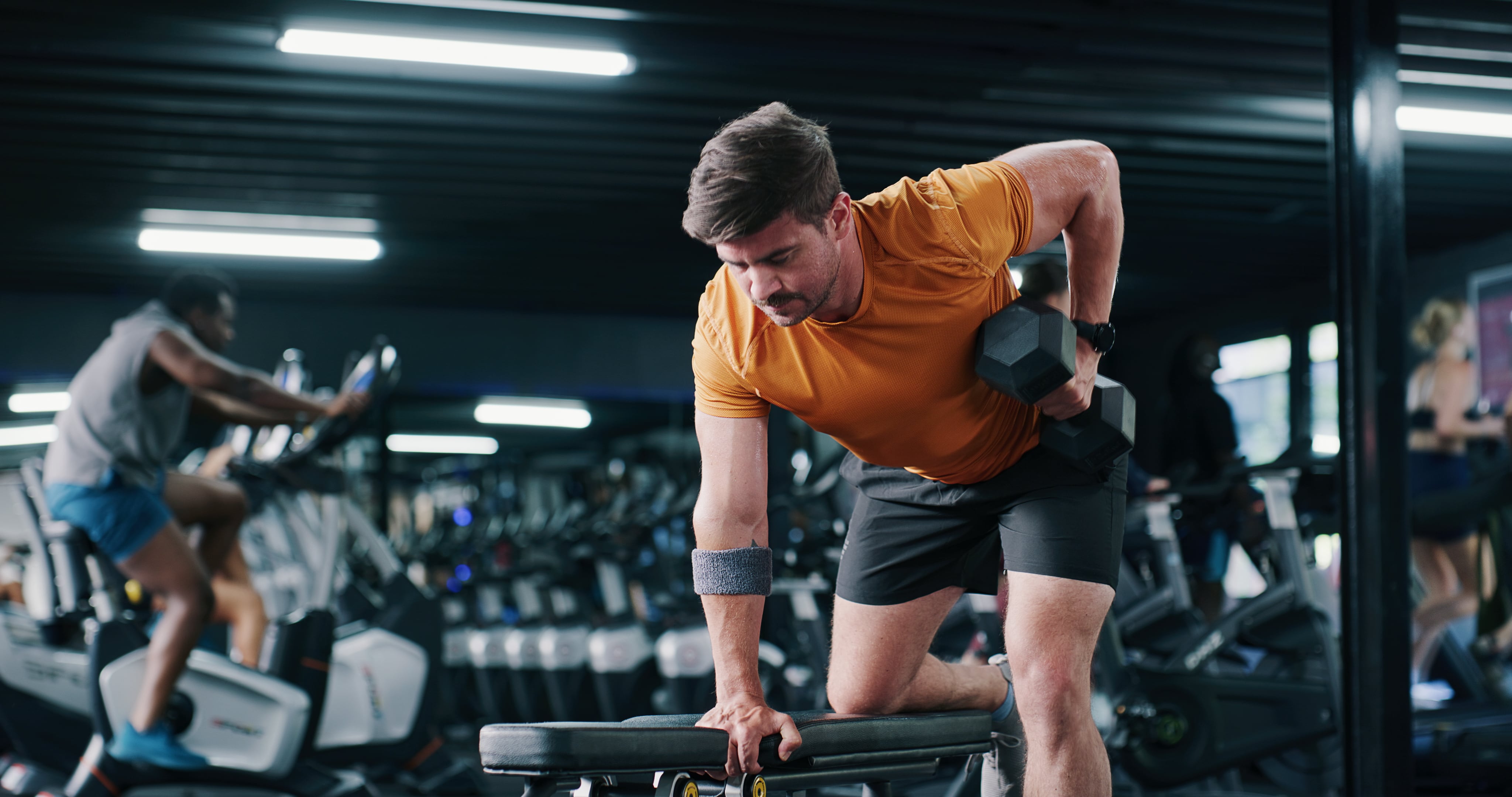 Fitness, man and training with dumbbell row in gym for muscle development, power and energy. Weightlifting, bodybuilder and strong person exercise for resistance workout, wellness challenge or health