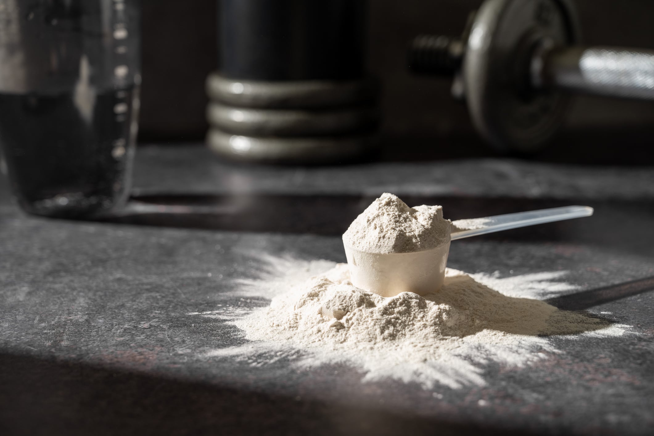 Protein shake and chocolate protein powder in a scoop, Sports nutrition.