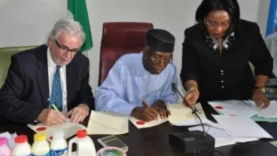 Hon. Minister Chief Audu Ogbeh and chairman of L&Z Integrated Dairy Farm, Keith Richards, sign a dairy MoU in the Nigerian capital, Abuja.
