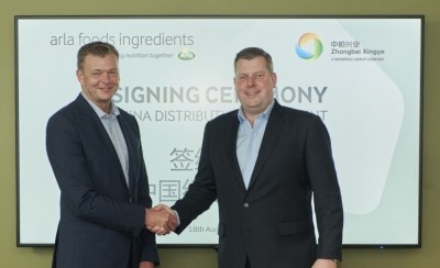 Luis Cubel, commercial director of Arla Foods Ingredients shakes hands with Michael Friede, CEO of Brenntag Specialties