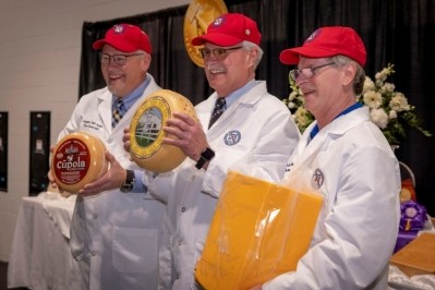 From left: Assistant chief judge Tim Czmowski holding the Vintage Cupola American Original; chief judge Jim Mueller holding the US Chmapion, Europa by Arethusa Family Farms, and director of logistics Randy Swensen holding the Medium Cheddar by Associated Milk Producers Inc.