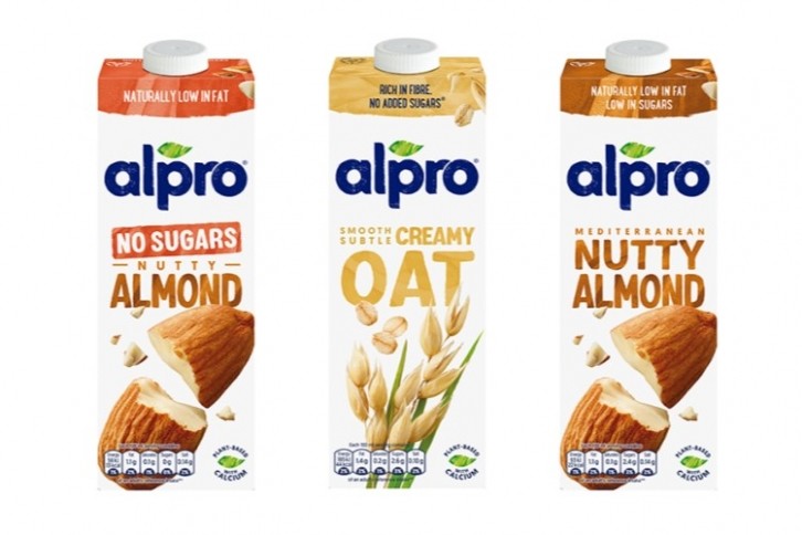 Alpro's Almond and Oat lines will carry a custom 'red label' packaging showing the €2 price tag, though some retailers have opted to highlight the new pricing through on-shelf advertising. Image via Danone/Alpro