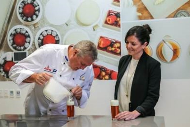 Anchor Food Professionals chef Keith McDonald makes tea macchiatos with Fonterra’s Susan Cassidy.