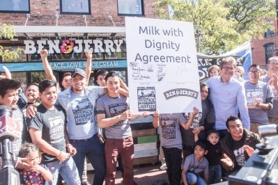 Ben & Jerry's CEO, Jostein Solheim, and dairy farm workers hold up a version of the signed Milk with Dignity agreement. Photo: Migrant Justice 